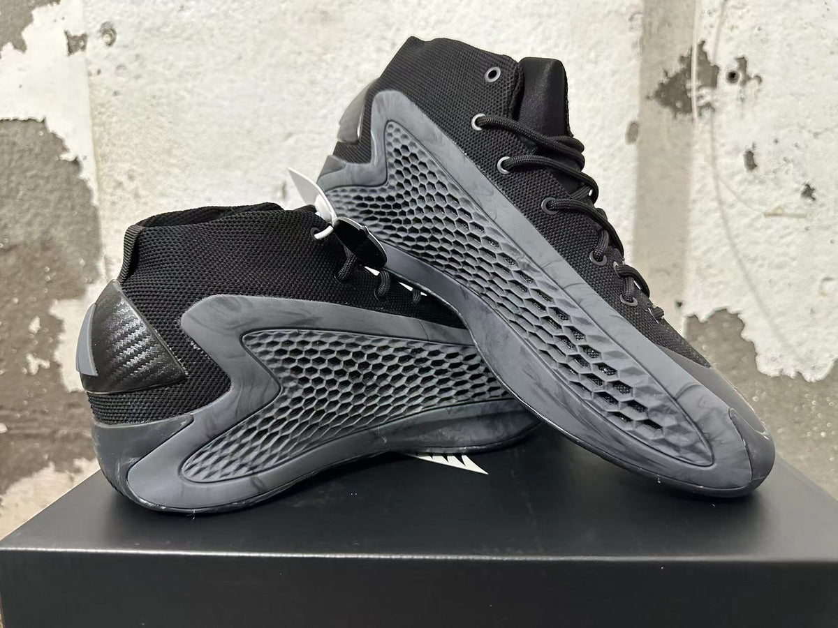 Two black high-top sneakers displayed at an angle, showing their textured side panels and lace-up fronts.