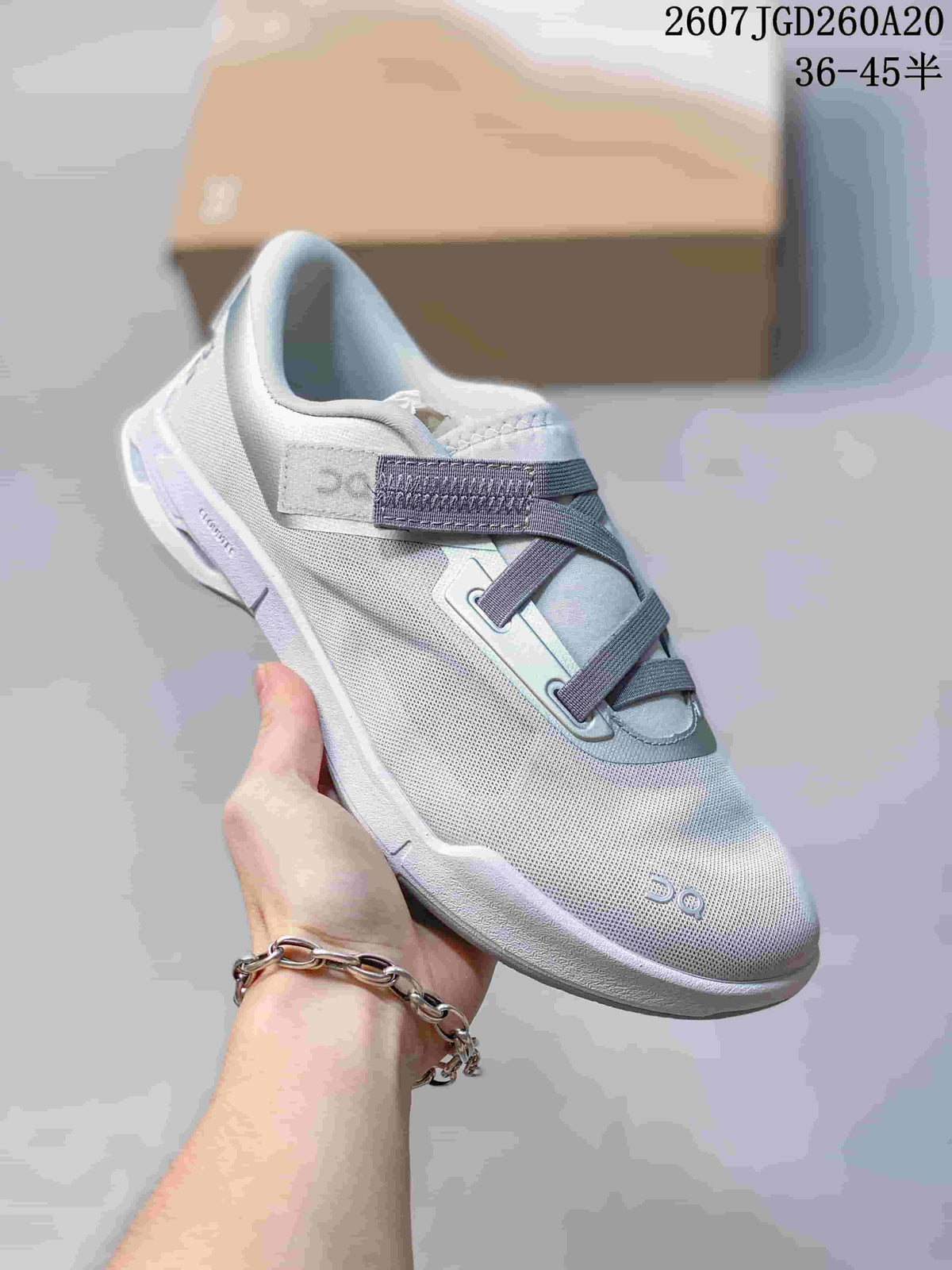 Close side view of a white On Cloudnova Moon sneaker showing the pale accent details, padded collar, and raised sole.
