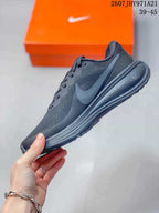 Side profile of the black Nike running sneaker showing the textured upper, Swoosh branding, laces, and cushioned sole.