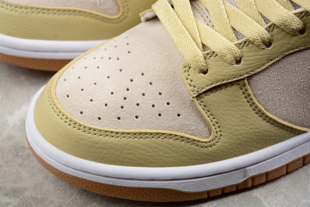 Close-up of the perforated light-colored toe box, sesame overlays, white midsole, and gum outsole