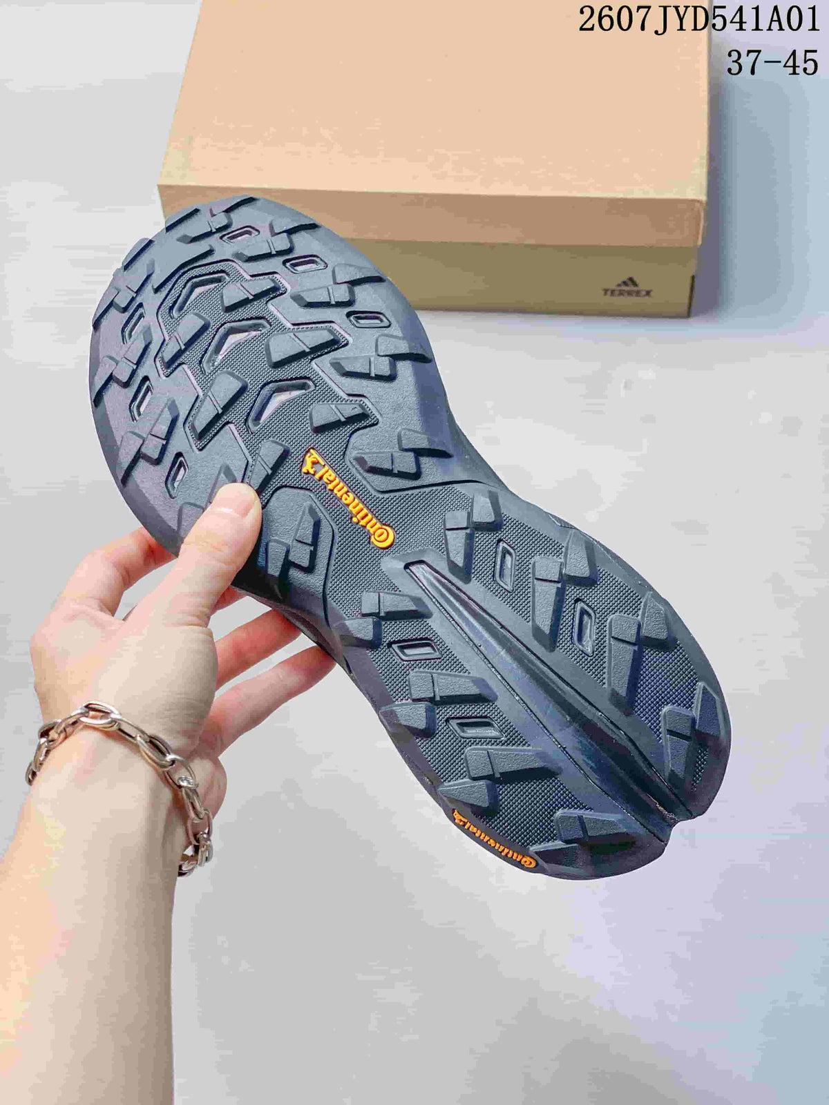 Close-up of the patterned outsole on a dark gray outdoor shoe
