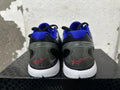 Rear view of gray camouflage Nike basketball shoes with blue lining, translucent-looking heel details, and red signature graphics.