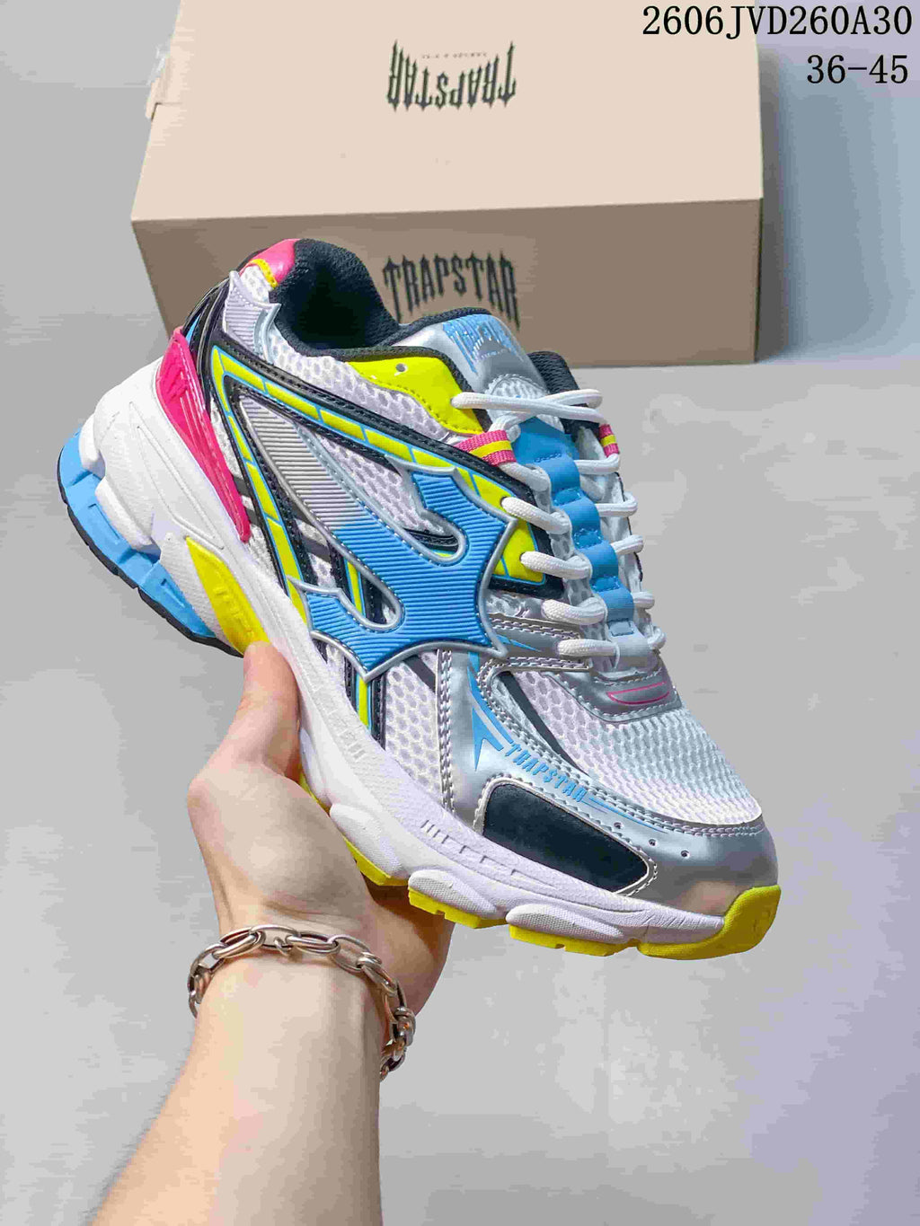 White, silver, blue, yellow, and pink Trapstar Trispeed 3000 sneaker.