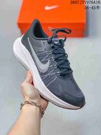Angled side view of the Nike Zoom Winflo 8 sneaker with dark upper, contrasting side logo, and white midsole.