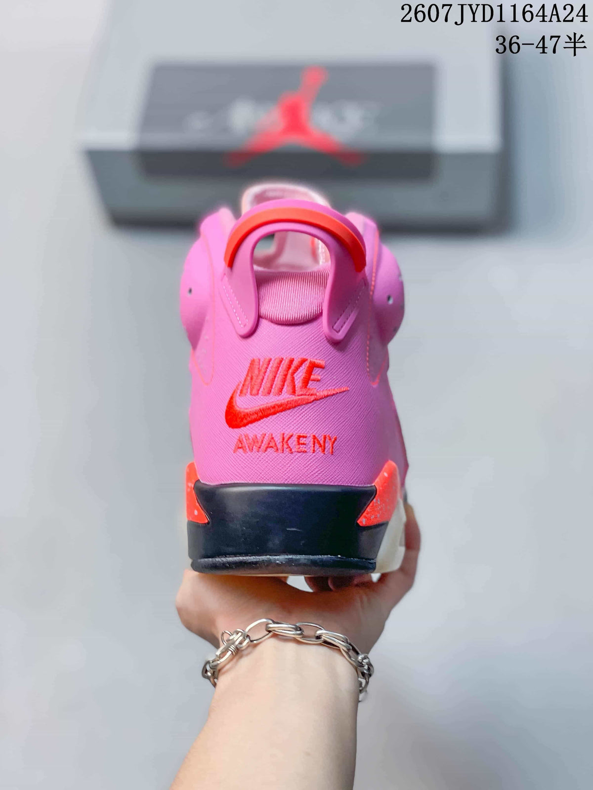 Rear view of the pink sneaker showing the embroidered Nike and “AWAKEN NY” heel branding, pull tab and layered heel structure.