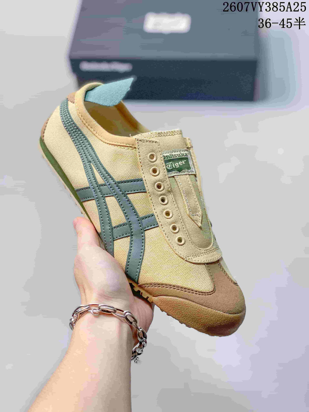 Tan slip-on sneaker with muted blue-green side stripes and a brown-toned outsole.