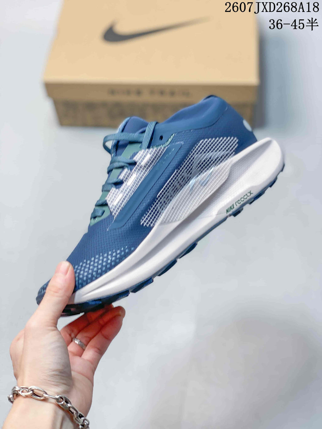 Side profile of the blue sneaker showing mesh-style panels, white midsole, and dark outsole tread.