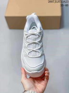 Top view of a white sneaker showing the mesh toe box, tongue branding and looped lace arrangement.