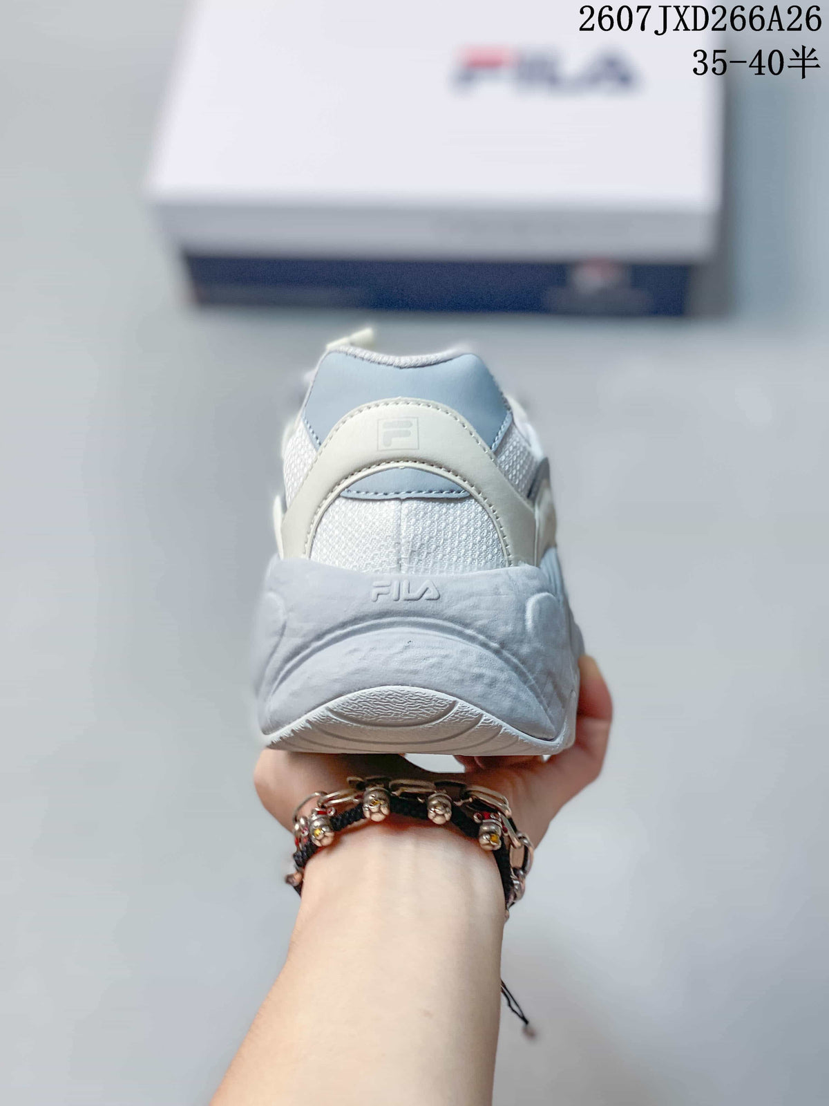 Rear view of the white and gray sneaker showing the padded heel, mesh panel, and FILA branding.