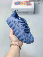 Blue Nike Mind 002 kids sneaker with matching laces, pull tab and textured outsole.