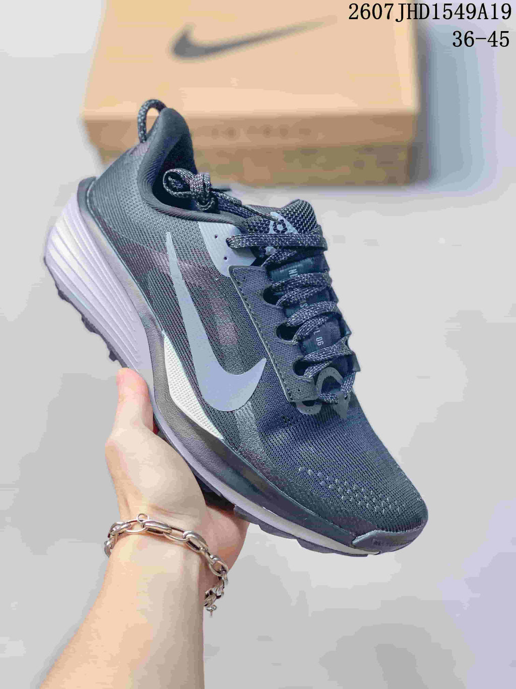 Dark gray Nike Zoom Fly 5 sneaker with a pale blue Swoosh and contrasting layered sole.