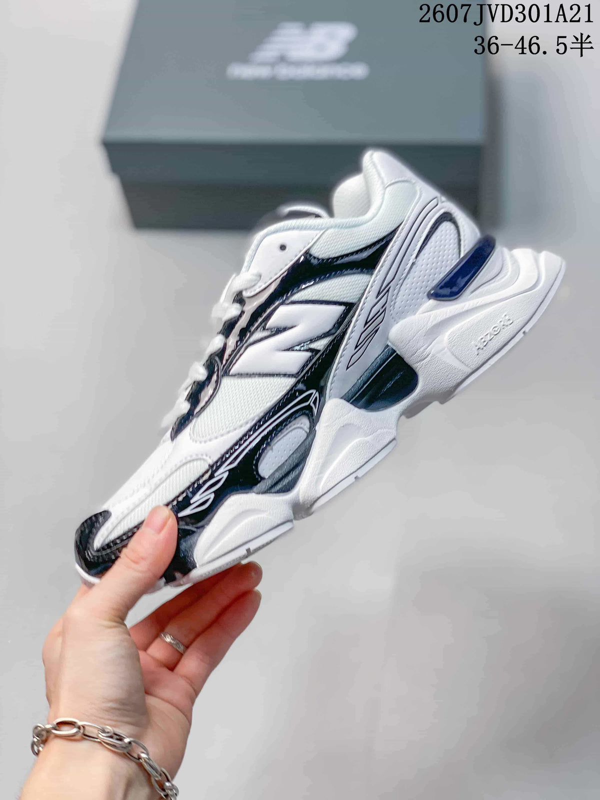 Side profile of the New Balance 9060R sneaker showing layered panels, contrasting accents, and a sculpted sole.