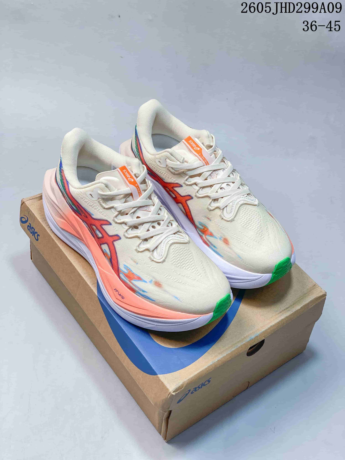 Pair of cream ASICS Superblast 3 running shoes with coral, blue, and green accents on a shoebox