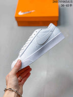 Side view showing the white upper, Swoosh branding, stitching and low-top profile.
