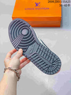 Bottom view of the sneaker showing a dark textured rubber outsole with circular traction details.