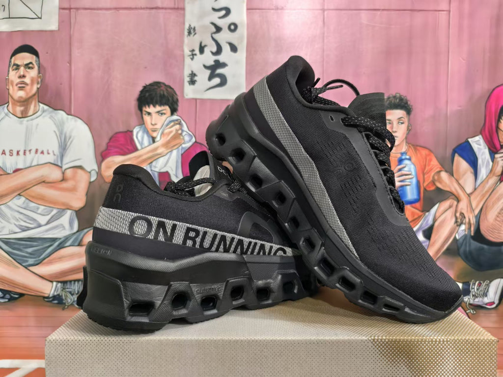 Pair of black On Running sneakers displayed at an angle, showing their side bands and chunky soles.