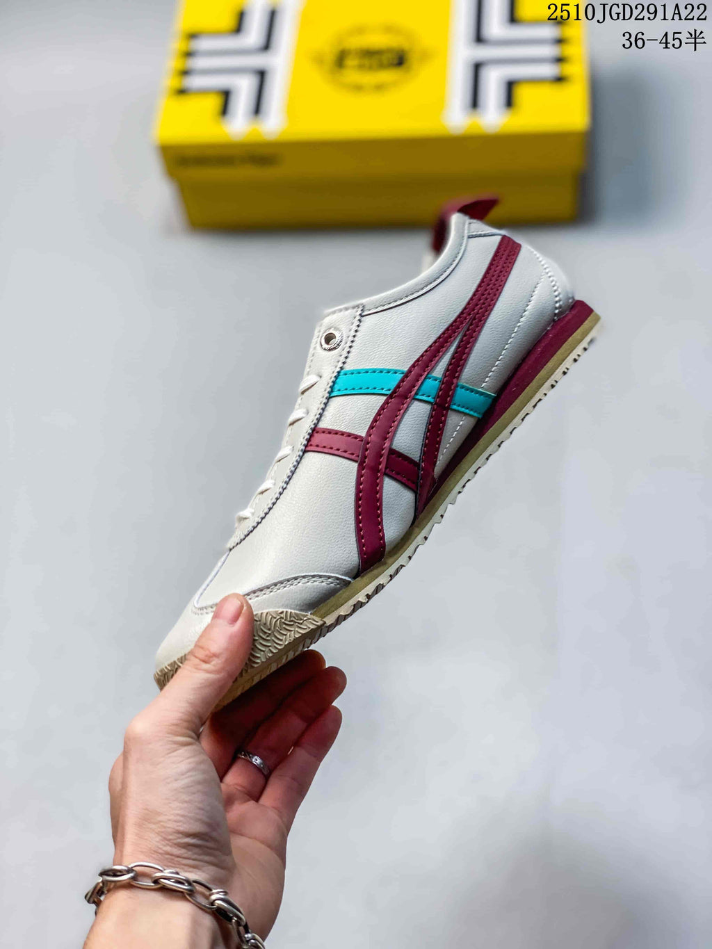 Side view of a white Onitsuka Tiger sneaker with burgundy and turquoise stripes, white upper, and gum-colored outsole.