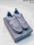 Pair of gray Emporio Armani EA7 low-top sneakers displayed on a branded shoe box, with the style code and EU size range visible above.