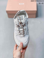 Top view showing the mesh toe box, layered lace area, brown laces, and branded tongue label.