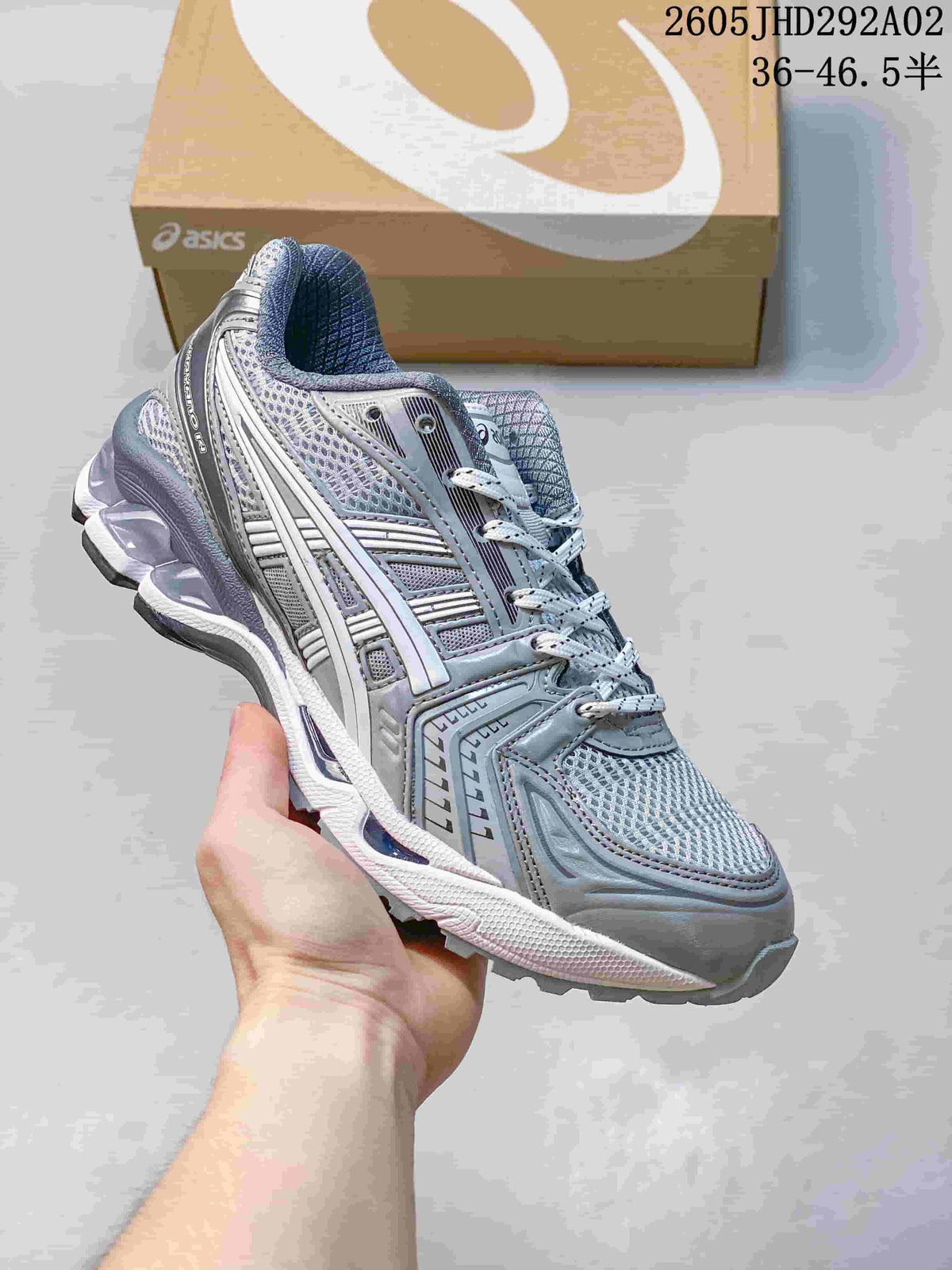 ASICS GEL-KAYANO 14 sneaker in silver and pale blue, shown at an angled front-side view.
