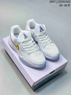 Pair of white Nike JA 2 EP basketball shoes with multicolor speckling, yellow side accents, and a shoe box behind them.