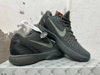 Pair of dark Nike Kobe 6 shoes shown from the side, highlighting the textured finish and heel design