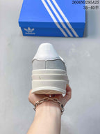 Rear view showing the white heel panel, grey upper, and layered platform sole.