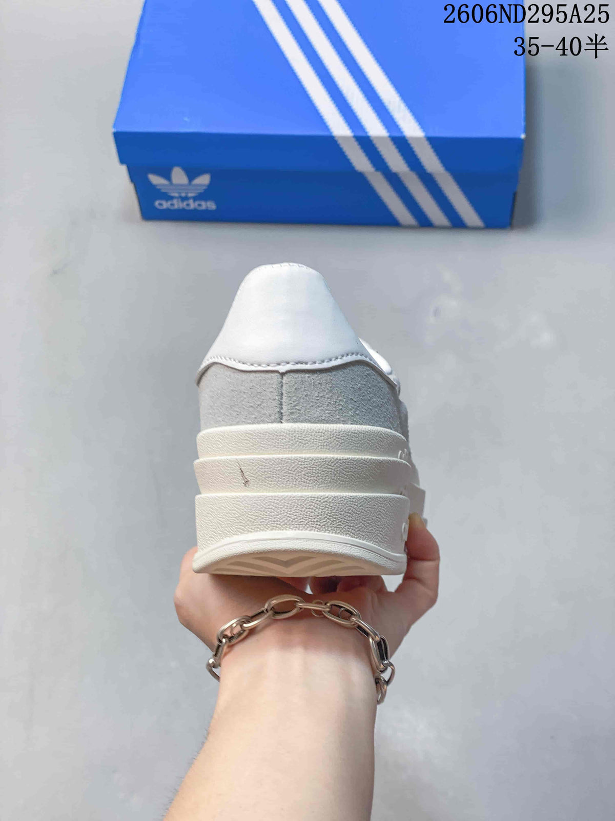 Rear view showing the white heel panel, grey upper, and layered platform sole.