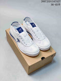 Pair of white and blue DESCENTE Cron Tempo sneakers displayed on a shoebox.