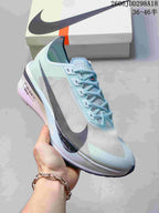 Angled side view of the Nike road-racing shoe showing its pale blue and white upper, dark Swoosh, lace-up closure, and sculpted midsole.