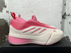 Side profile of a pink and cream Adidas Dame 9 basketball shoe
