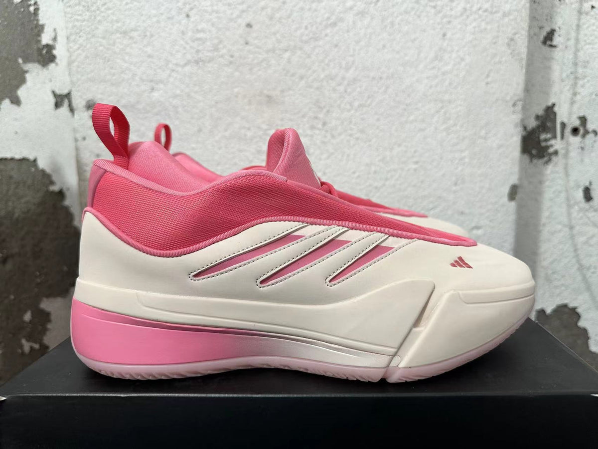Side profile of a pink and cream Adidas Dame 9 basketball shoe