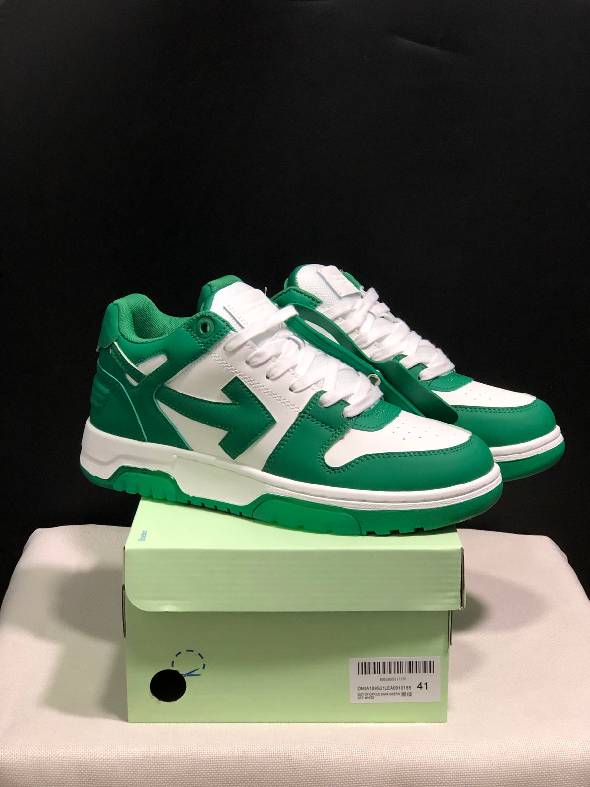 Green and white Off-White Out Of Office low-top sneakers displayed on a shoebox, with a visible size 41 label.