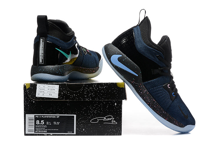 Black and navy Nike PG 2 shoe beside its box, showing the PG 2 PlayStation EP label and sample size 8.5