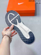 Underside view of the sneaker showing the dark rubber outsole with a segmented tread pattern.