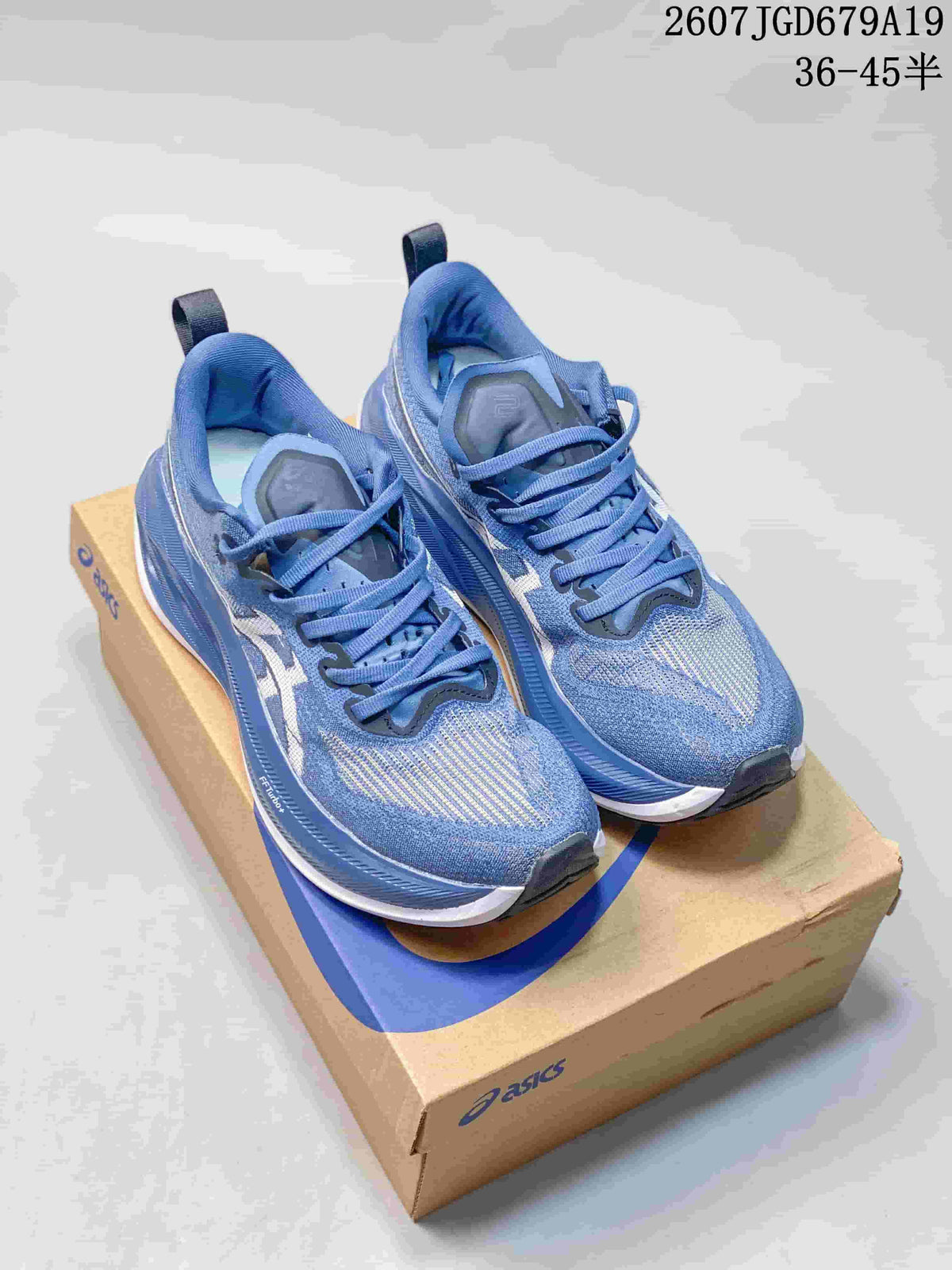 Pair of blue ASICS SUPERBLAST 2 running sneakers displayed on an ASICS shoe box; image text shows style code 2607JGD679A19 and a size range marked 36–45.5.