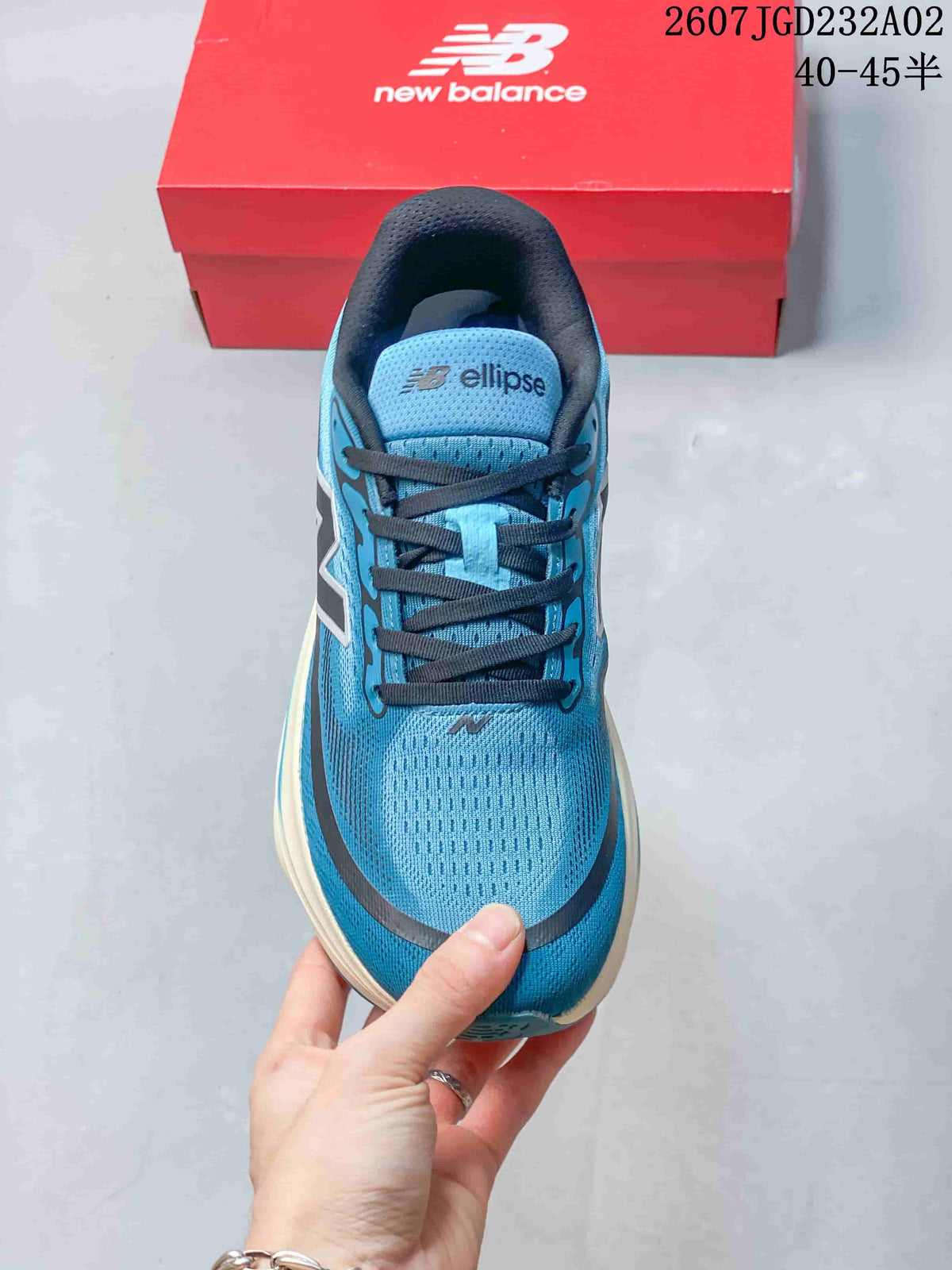 Top view of a blue lace-up running shoe with an Ellipse tongue label