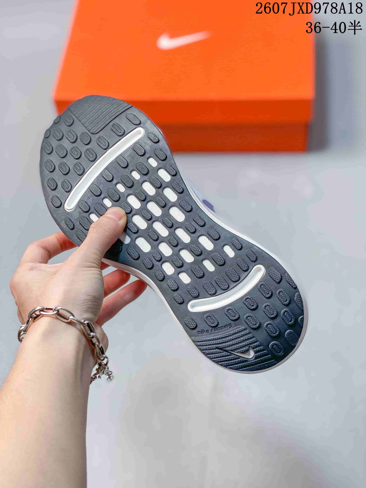 Close view of the Nike Journey Run rubber outsole showing its textured traction pattern and curved white inserts.