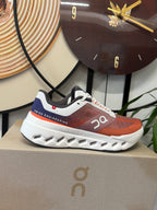 On Cloudsurfer Running Shoes in Rust and White