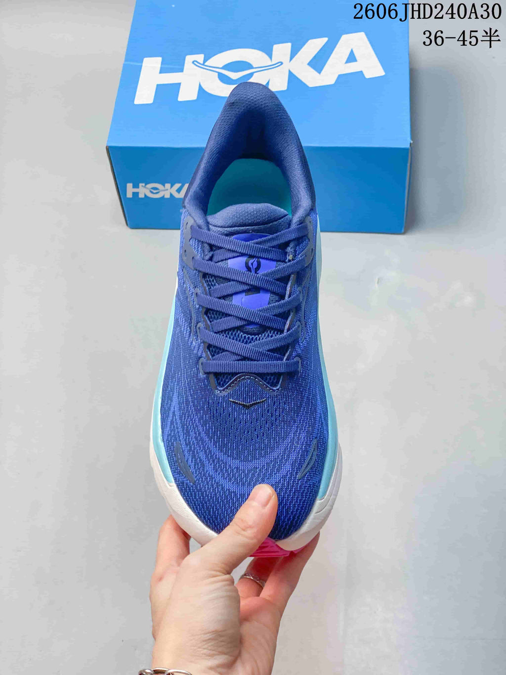 Top view of a blue running shoe showing its laces and upper