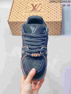 Top view of the navy sneaker with thick laces and decorative logo details