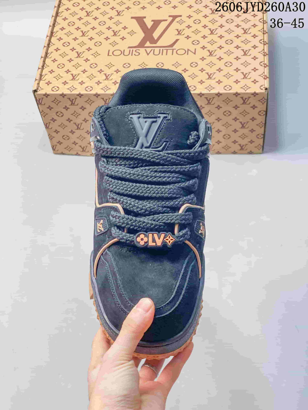 Top view of the navy sneaker with thick laces and decorative logo details