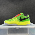 Side view of a bright green low-top Nike sneaker with a yellow midsole, black side logo, red laces, and white outsole section.