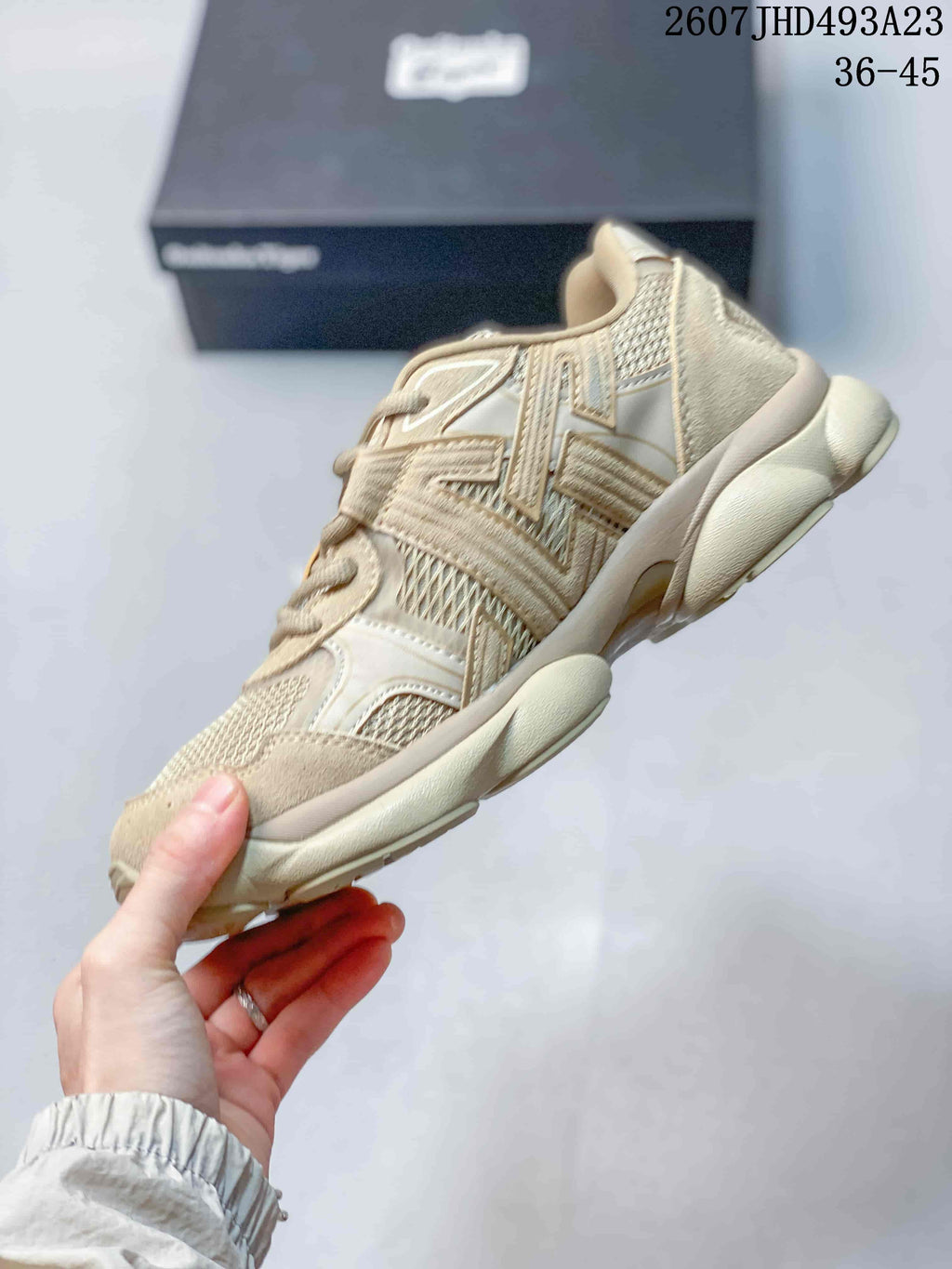 Side profile showing the layered upper panels and chunky outsole of the beige and cream TIGRUN sneaker.