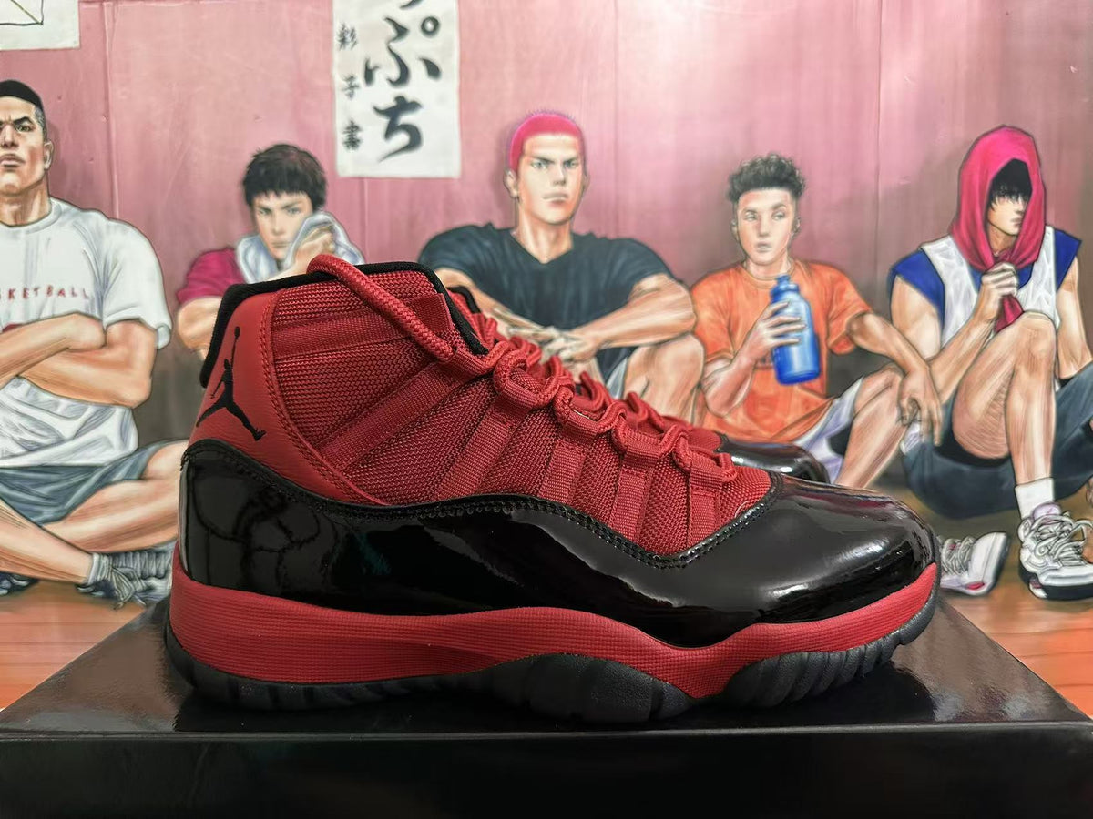 Side view of a black and red high-top sneaker with red textile panels, glossy black overlays, and a textured outsole.