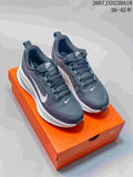 Pair of dark gray and white Nike Vomero 18 GTX running shoes displayed on an orange shoebox.