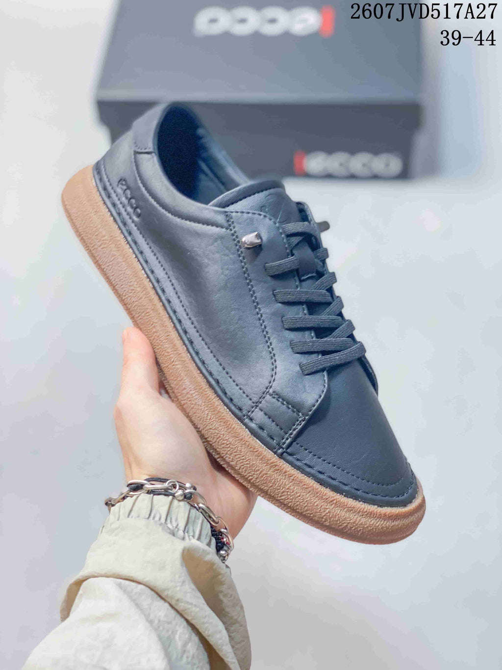 Angled side view of the dark navy sneaker showing the low-top silhouette, stitched panels, ECCO branding, and textured gum-colored sole.