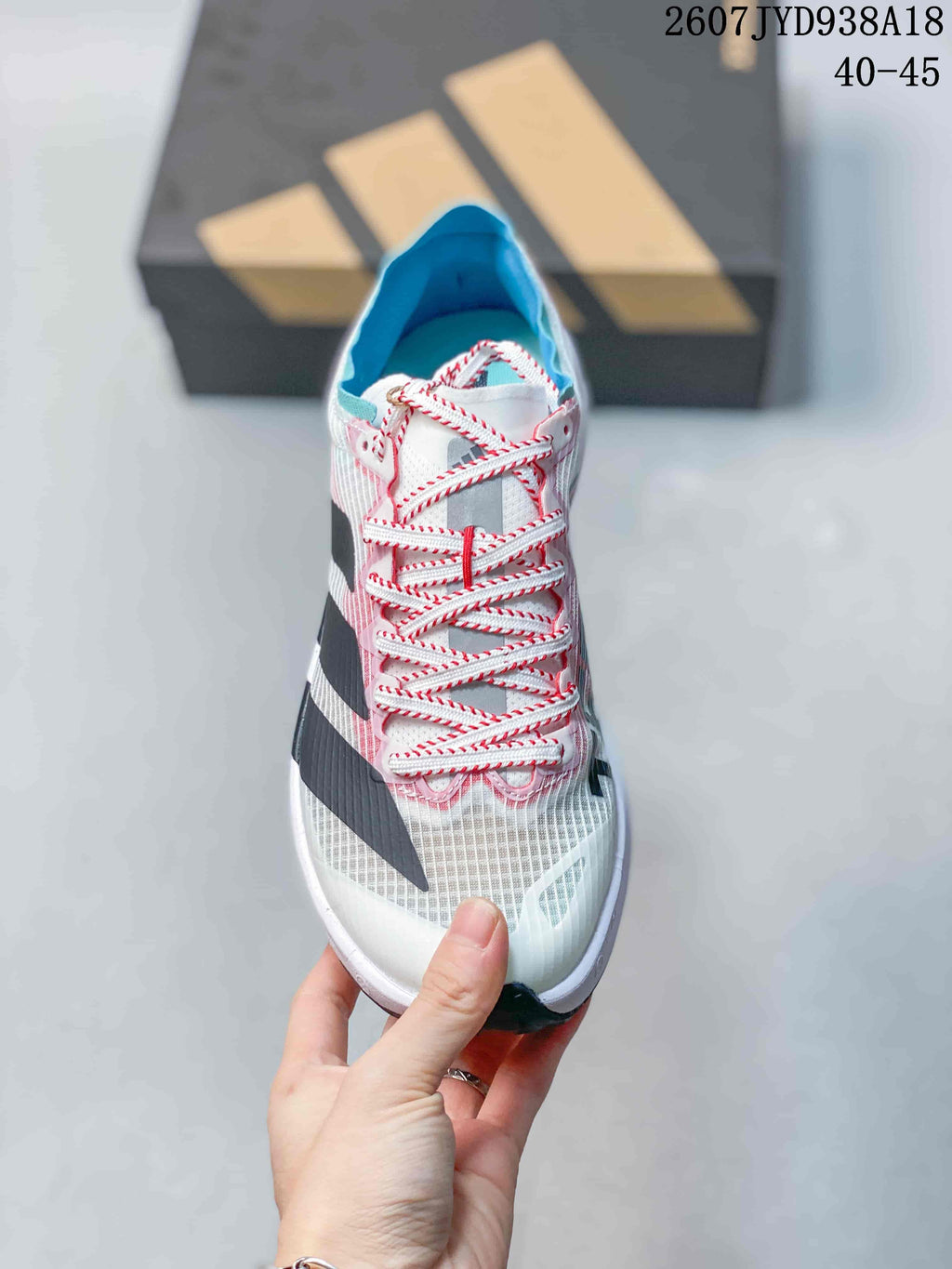 Top view of the shoe showing the mesh-style toe area, red-and-white laces, blue lining, and contrasting side stripes; size range text 40–45 is visible.