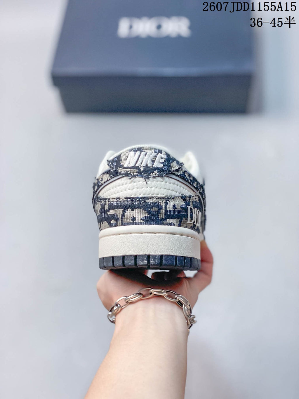 Rear view of the sneaker showing patterned heel panels, white midsole, dark outsole, and Nike branding on the heel tab.