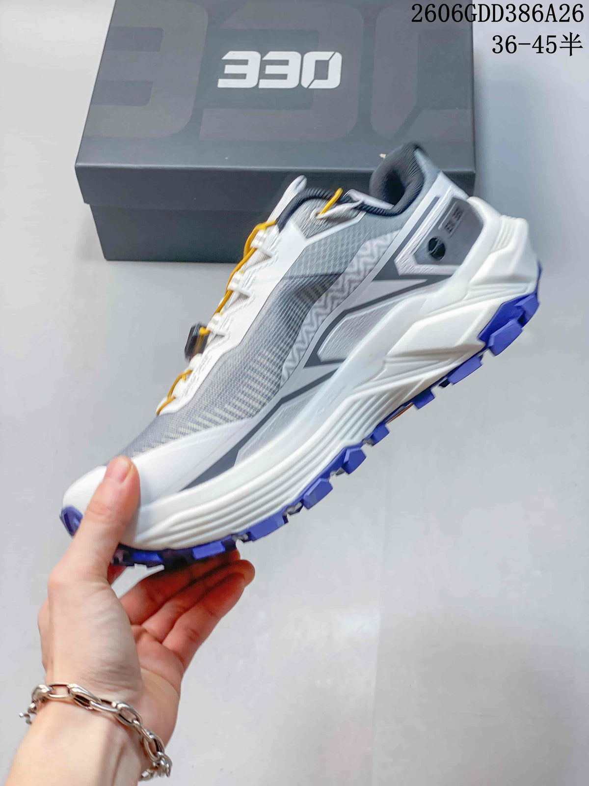 Side view of a white and gray Kailas FUGA EX330 trail running shoe